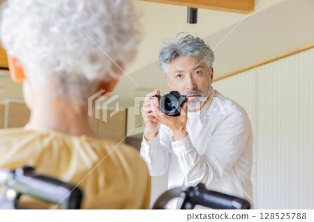Senior couple taking pictures with a single-lens reflex camera Senior couple taking pictures with a single-lens reflex camera 128525788