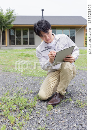 Workers conducting geological survey 128525803