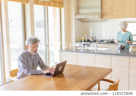 Senior couple relaxing in the dining kitchen Senior couple relaxing in the dining kitchen 128525896