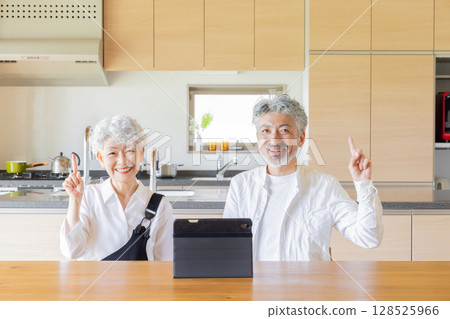 Senior couple using a tablet together Senior couple using a tablet together 128525966