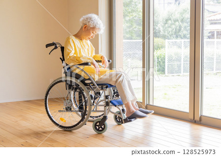 Senior woman in a wheelchair Senior woman in a wheelchair 128525973