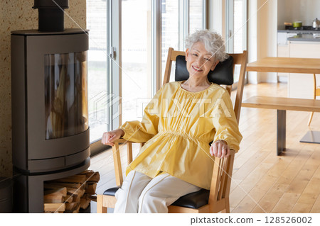Senior woman relaxing in a rocking chair Senior woman relaxing in a rocking chair 128526002
