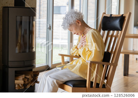 Senior woman suffering from chest pain 128526006