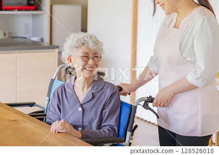 Caregiver wheelchair senior woman and helper 128526018