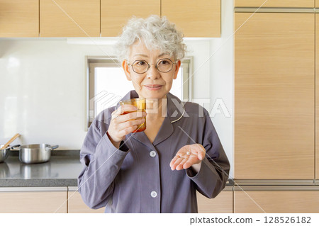 senior woman taking medicine senior woman taking medicine 128526182