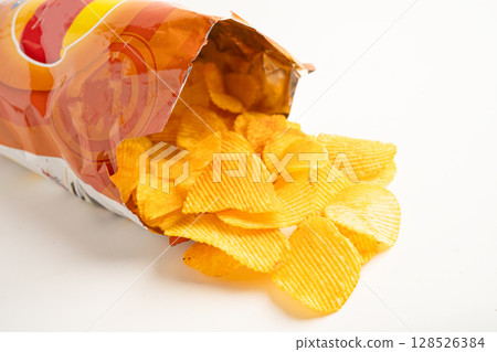 Potato chips deep fried snack fast food in open bag. 128526384