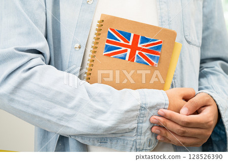 Learn English language, Asian teenage student hold book with flag in course at school. Learn English language, Asian teenage student hold book with flag in course at school. 128526390