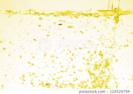 Water pouring into aquarium on yellow background. Water pouring into aquarium on yellow background. 128526709