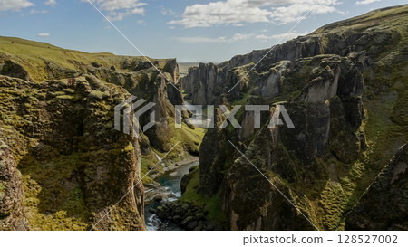 Fjadrargljufur Canyon and the shallow creek which flows along the bottom of the canyon, Southern Iceland Fjadrargljufur Canyon and the shallow creek which flows along the bottom of the canyon, Southern Iceland 128527002