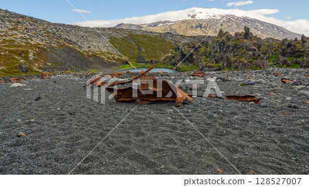 Rusty remains of a shipwreck lie scattered on Djupalonssandur beach, Snaefellsjokull National Park, Iceland. 128527007