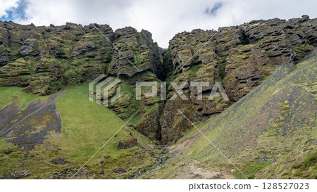 Rauofeldsgja ravine on Snaefellsbaer Peninsula, surrounded by rugged volcanic cliffs and pristine natural beauty in Iceland. 128527023
