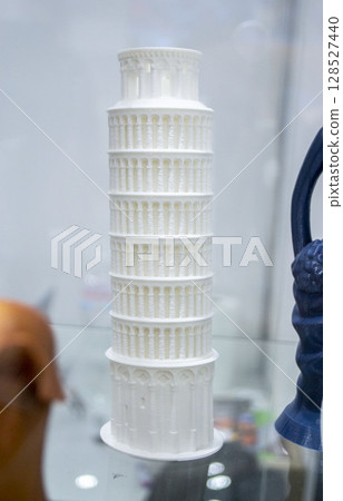 Art object printed on 3D printer. Model created on 3D printer from white molten plastic. Creative tower shape printed on 3D printer. Additive progressive high-tech technology. 3D printing technology Art object printed on 3D printer. Model created on 3D printer from white molten plastic. Creative tower shape printed on 3D printer. Additive progressive high-tech technology. 3D printing technology 128527440