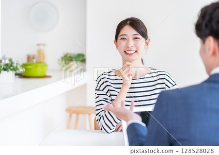 A young housewife consulting a financial planner. A young housewife consulting a financial planner. 128528028