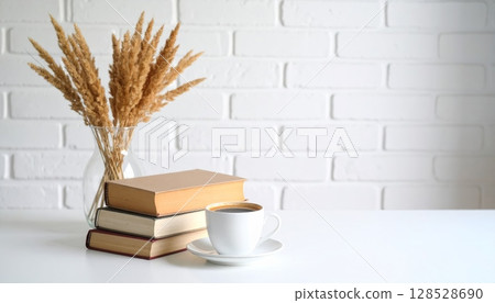 Coffee mug and book on table, white brick wall background Coffee mug and book on table, white brick wall background 128528690