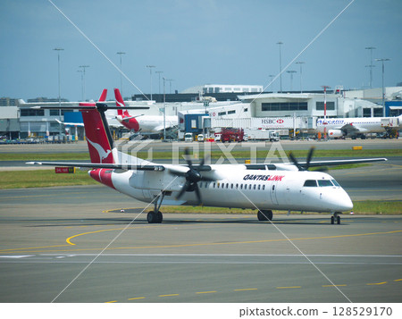 Qantaslink DHC-8 departing Sydney Airport 128529170