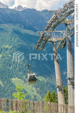 Modern Cable Car Ascends Alpine Mountains on a Sunny Summer Day. High quality photo Modern Cable Car Ascends Alpine Mountains on a Sunny Summer Day. High quality photo 128529537