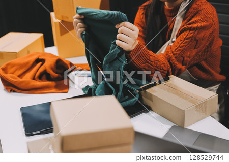 Portrait of Starting small businesses SME owners, two Asian woman check online orders Selling products working with boxs freelance work at home office, sme business online small medium enterprise Portrait of Starting small businesses SME owners, two Asian woman check online orders Selling products working with boxs freelance work at home office, sme business online small medium enterprise 128529744