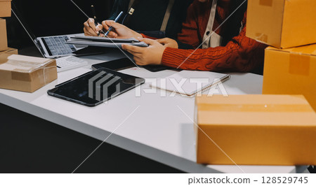 Portrait of Starting small businesses SME owners, two Asian woman check online orders Selling products working with boxs freelance work at home office, sme business online small medium enterprise 128529745