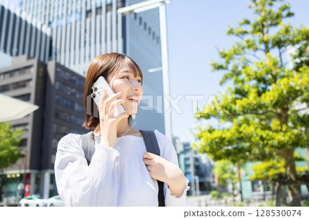 Young woman speaking on smartphone Young woman speaking on smartphone 128530074