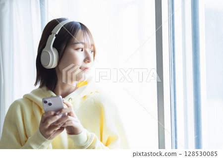 A woman listening to music A woman listening to music 128530085