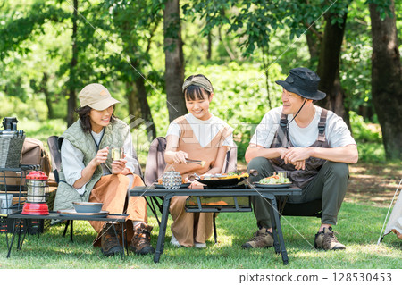 A friendly family enjoying day camping, camping and barbecues at a park or campsite A friendly family enjoying day camping, camping and barbecues at a park or campsite 128530453