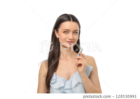 Woman with long hair holds skincare item, smiling, isolated on white, PNG 128530991