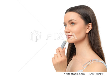 Woman with long hair applies lip balm on her lips, isolated on white, PNG 128530993