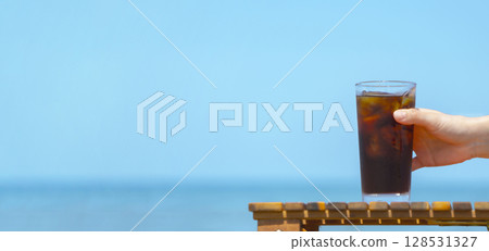 Drink iced coffee at the beach 128531327