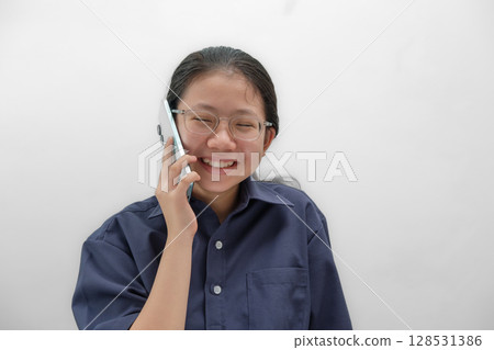Portrait Asian Thai Girl Laughing While on Phone Call Portrait Asian Thai Girl Laughing While on Phone Call 128531386
