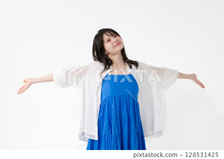 A young woman taking a deep breath 128531425