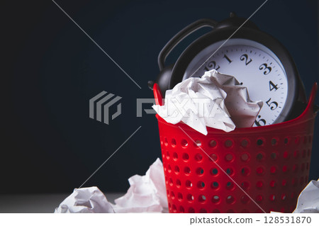 Early rise. Alarm clock in the trash. Woke up. Clock in the trash can. 128531870