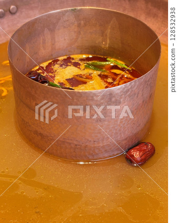 Closeup of a fresh hot pot broth, ready to be boiled and to add in food ingredient. 128532938
