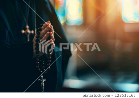 A man holds a cross in his hands and prays intently in a Christian church, AI generation 128533165