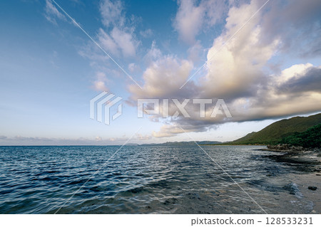 A view of the evening clouds spreading over the quiet sea of Ishigaki Island, ALOALO Beach 128533231