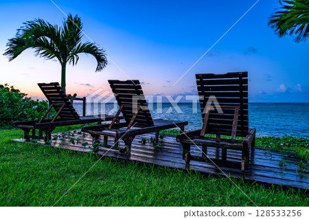 Sunset on Ishigaki Island, sitting on a beachside resort chair 128533256