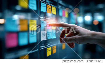 hand point tickly notes on an agile board during a collaborative workshop. hand point tickly notes on an agile board during a collaborative workshop. 128533423