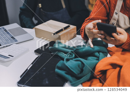 Portrait of Starting small businesses SME owners, two Asian woman check online orders Selling products working with boxs freelance work at home office, sme business online small medium enterprise 128534049