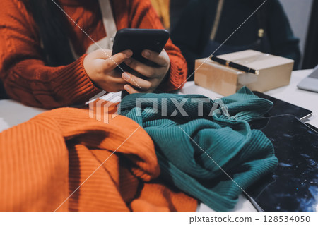 Portrait of Starting small businesses SME owners, two Asian woman check online orders Selling products working with boxs freelance work at home office, sme business online small medium enterprise 128534050