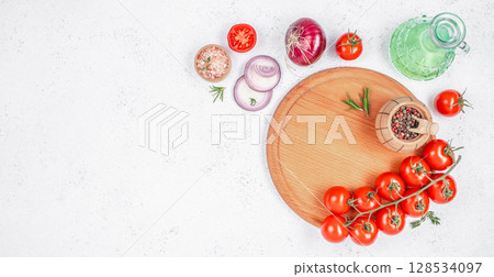 Fresh organic ingredients including cherry tomatoes, red onion, pink salt, rosemary, pepper and olive oil arranged on a wooden cutting board for cooking or salad preparation Fresh organic ingredients including cherry tomatoes, red onion, pink salt, rosemary, pepper and olive oil arranged on a wooden cutting board for cooking or salad preparation 128534097