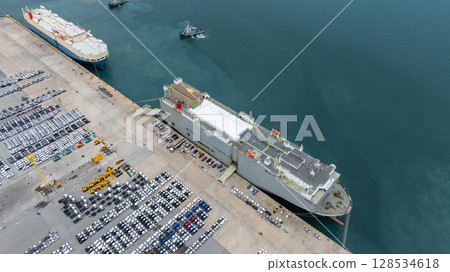 Aerial view vehicles carrier and new cars for import export transportation logistic, Vehicles carrier at industrial RoRo terminal port, Vehicles carrier global business logistic import export new car Aerial view vehicles carrier and new cars for import export transportation logistic, Vehicles carrier at industrial RoRo terminal port, Vehicles carrier global business logistic import export new car 128534618