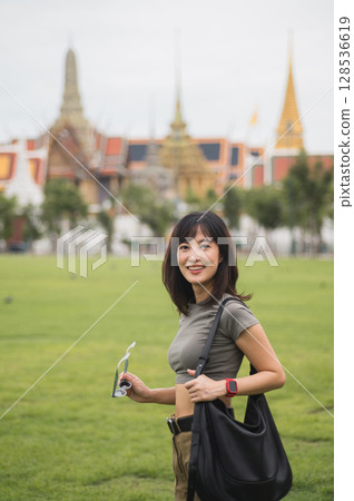 Happy solo southeast asian woman teenager blogger on world travel. joyful explorer enjoying local cultural tourism experience in Bangkok Thailand great asia tourism concept 128536619