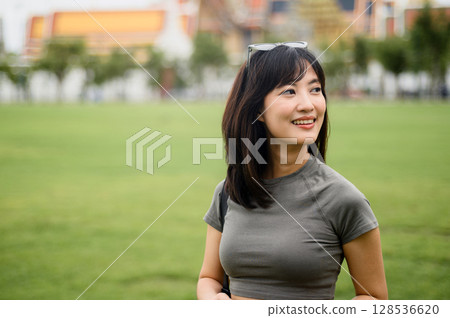 Happy solo southeast asian woman teenager blogger enjoying world travel tourism concept. local cultural explorer experience in Bangkok Thailand asia Happy solo southeast asian woman teenager blogger enjoying world travel tourism concept. local cultural explorer experience in Bangkok Thailand asia 128536620