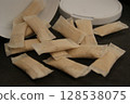 Packaging and nicotine nicotine pouches on a dark background. Close-up. 128538075