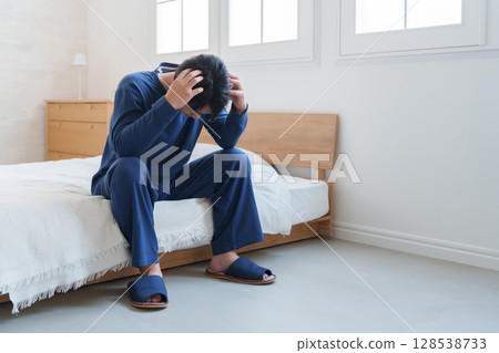 A man falling in bed 128538733