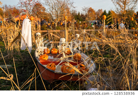 Funny Halloween decoration with ghost and skeletons in boat 128538936
