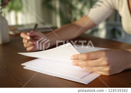 Woman hands holding and reading a document 128539382