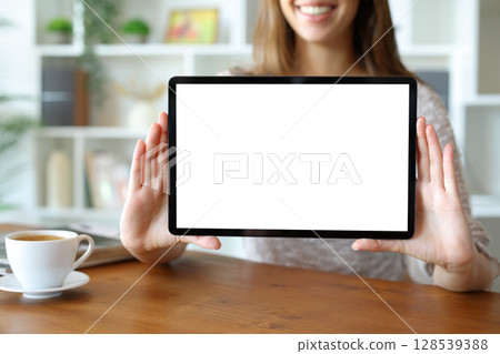 Woman hands showing blank tablet screen to camera 128539388