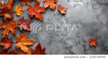 Vibrant Autumn Leaves on Concrete Background 128539440