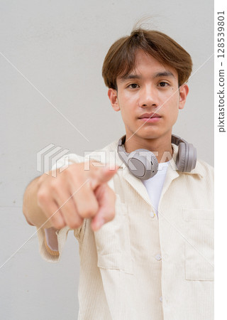 Non binary cute Asian young gay man pointing finger at you 128539801