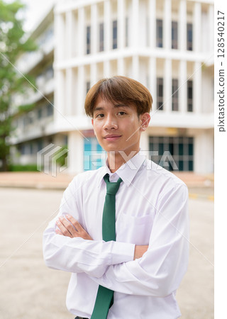 Non binary university student in college campus 128540217